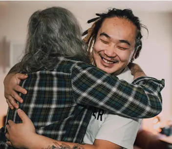 young man hugging an older woman