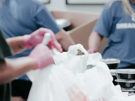 volunteers gathering bags and boxes for distribution